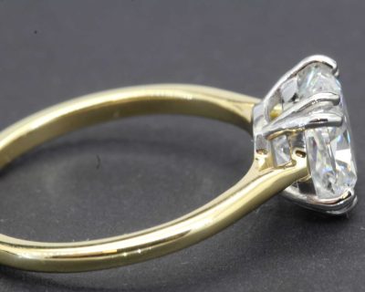 Engagement ring with a sparkling diamond in a gold setting.