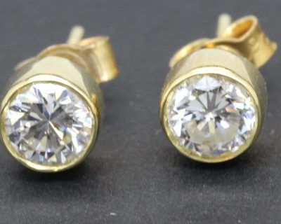 Gold and diamond stud earrings with sparkling gemstones for women.