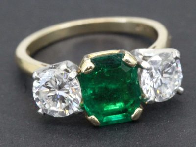 Elegant emerald and diamond ring with gold band.