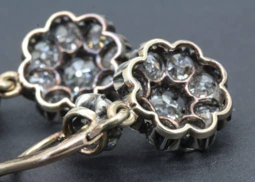 Diamond flower pendant with sparkling gemstones in a silver setting.