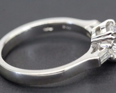 Engagement ring featuring a sparkling solitaire diamond set in a sleek silver band. Perfect for spec.