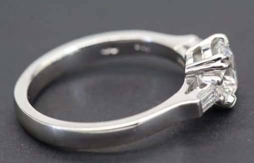 Engagement ring featuring a sparkling solitaire diamond set in a sleek silver band. Perfect for spec.