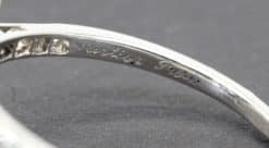 Elegant Cartier diamond ring with engraved inscription.