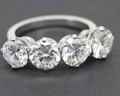 Sparkling diamond eternity ring with round-cut stones on a silver band.