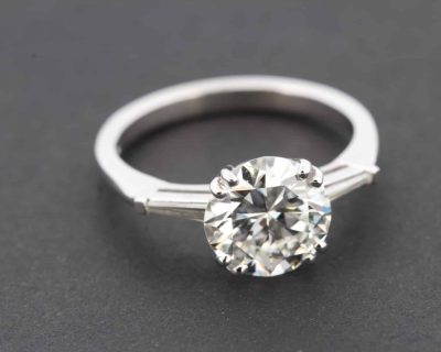Engagement ring with a large round-cut diamond on a silver band.