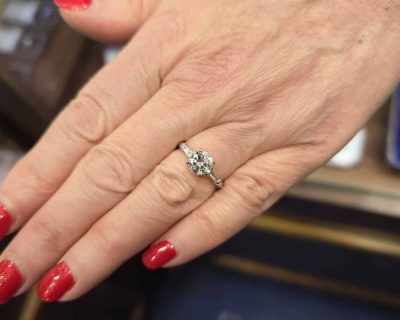 Engagement ring with a sparkling diamond on a woman's hand.