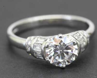 Diamond heart-shaped engagement ring with side stones, crafted in silver.