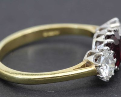 Gold ring with large red and clear diamonds, luxury jewelry piece.