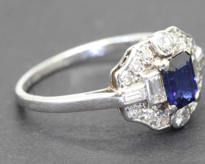 Silver ring with a central blue sapphire and surrounding diamonds, fine jewelry from Weldons Jewelle.