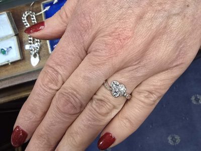 Diamond engagement ring on a woman's finger showcasing fine jewelry.