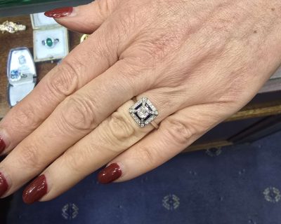 Diamond engagement ring with intricate design and sparkling stones.