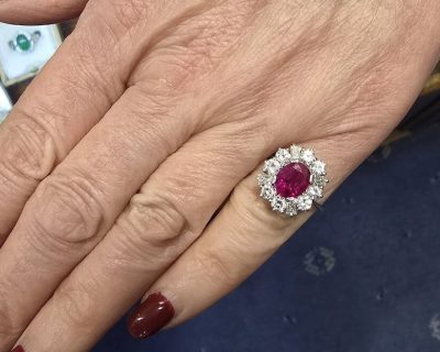 Elegant ruby and diamond ring on a woman's finger.