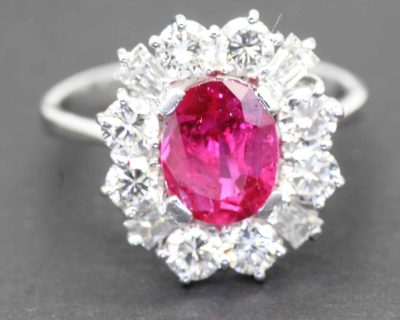 Pink ruby surrounded by sparkling diamonds in a luxurious halo setting.