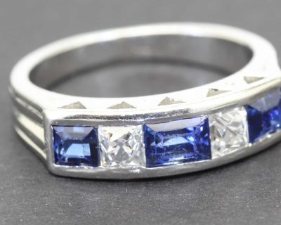 Elegant sapphire and diamond ring with a silver band, perfect for special occasions.