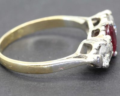 Elegant silver and gold ring featuring a striking red gemstone, perfect for special occasions or eve.