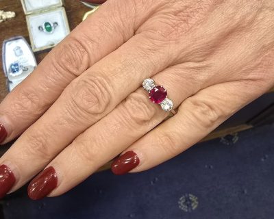 Ruby and diamond engagement ring on a woman's hand.