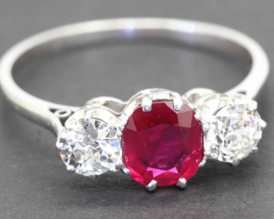 Stunning ruby and diamond ring with a central red gemstone and sparkling side stones.