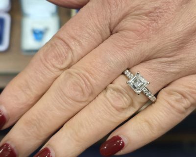 Stunning diamond engagement ring with a square cut center stone and pavé band.