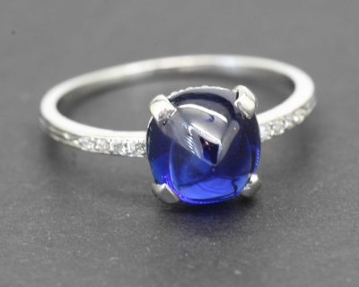 Stunning blue sapphire engagement ring with diamond accents in silver setting.