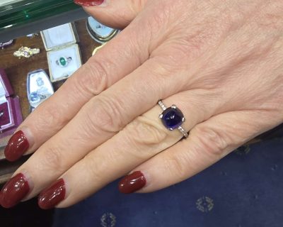 Elegant sapphire and diamond ring on a woman's finger.
