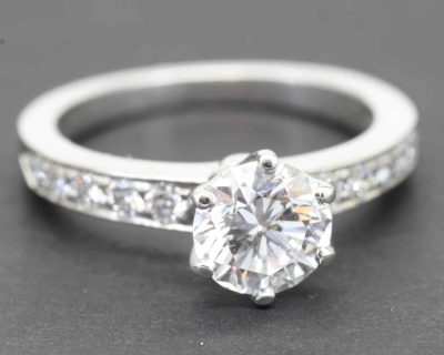 Elegant diamond engagement ring with a large central stone and pavé band, crafted by Weldons Jewelle.