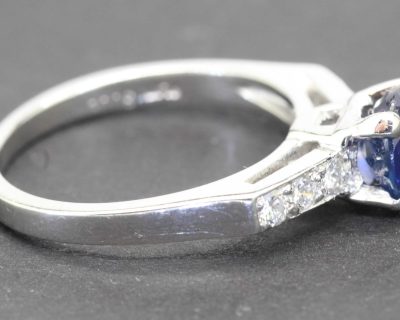 Sapphire and diamond engagement ring with a silver band, perfect for special occasions.