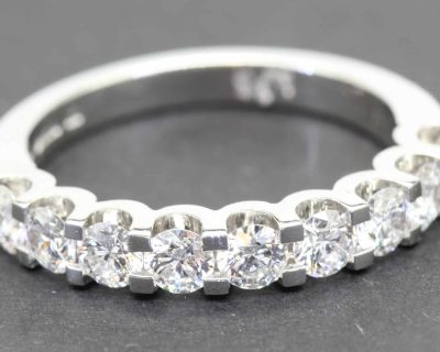 Elegant diamond eternity ring in white gold with sparkling round-cut stones.