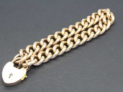 Elegant rose gold curb bracelet with a heart-shaped padlock charm. Perfect for stylish jewelry lover.