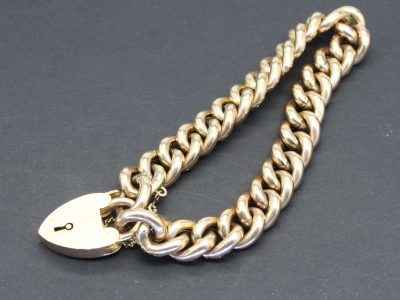 Gold chain with a padlock clasp for jewelry security and style.