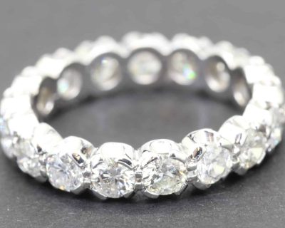 Diamond eternity ring with sparkling round-cut stones in a silver setting.