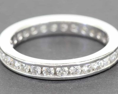 Diamond eternity ring with sparkling stones in a silver band.
