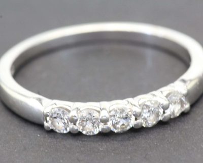 Diamond eternity ring with multiple sparkling stones in silver band.