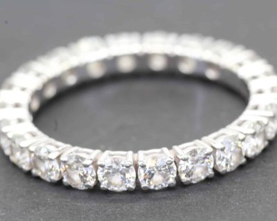 Diamond eternity ring with sparkling gemstones on a silver band.