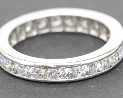 Elegant diamond eternity ring with sparkling stones in a platinum band.