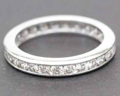 Diamond eternity ring with sparkling stones in a silver band.