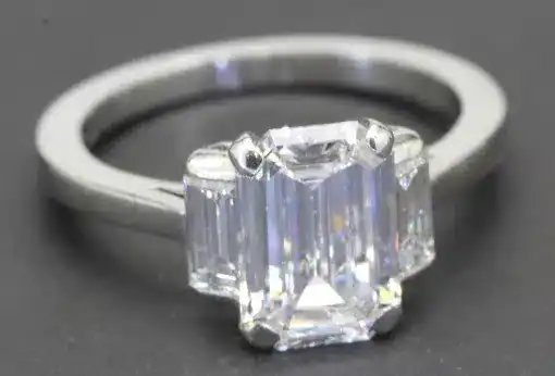 Elegant emerald cut diamond ring in silver band, perfect for special occasions.