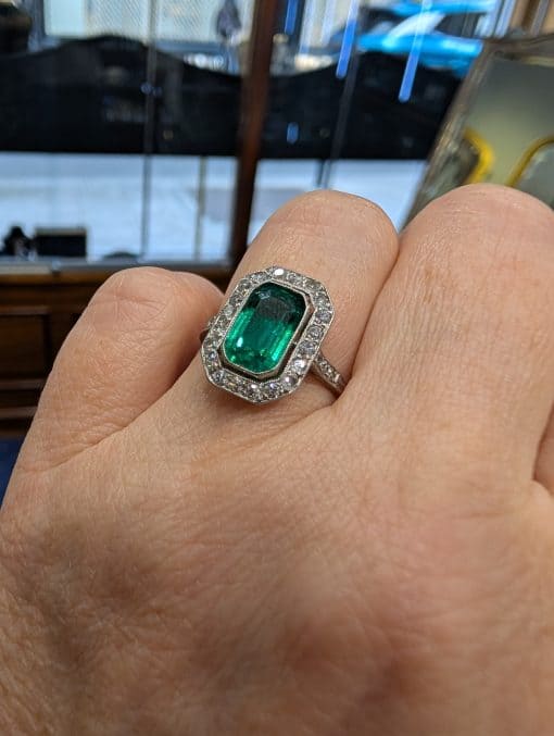 Emerald and diamond ring on hand