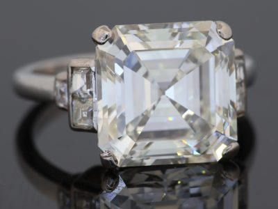 The Story & History An exceptional antique diamond ring centred by an impressive 6.7-carat diamond, mounted in platinum and framed by diamond-set shoulders. The scale of the principal stone gives the ring an unmistakable presence, while the platinum setting provides the refined, enduring foundation expected of a jewel of this calibre. The diamond is accompanied by a GIA certificate, documenting a J colour and VS clarity. Its substantial carat weight and classic solitaire-inspired composition make this a particularly striking piece for the serious diamond collector. Design & Details The 6.7-carat centre diamond is beautifully presented within a platinum mount, with graduated diamond-set shoulders adding brilliance and visual continuity to the design. Platinum is particularly well suited to a substantial diamond ring, providing strength and a naturally understated white-metal setting that allows the principal stone to remain the focus. The combination of a very large centre diamond, platinum construction and diamond shoulders creates a classic yet highly impressive silhouette. Styling & Wearability This is a statement diamond ring intended to command attention. The substantial centre stone gives it considerable presence on the hand, while the diamond shoulders provide additional sparkle without distracting from the principal diamond. Its classic proportions allow it to be worn as an exceptional engagement ring or simply as a significant diamond jewel for an established collection.