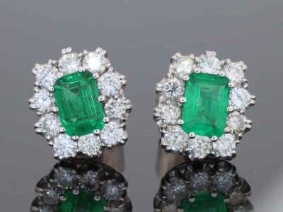 A beautiful pair of Colombian emerald and diamond cluster earrings, set in 18kt white gold. With a combined emerald weight of 1.88 carats, the earrings showcase the rich, unmistakable colour for which Colombian emeralds are so highly prized. The classic cluster arrangement gives these earrings an elegant presence while allowing the emeralds to remain the focal point. The combination of vivid green gemstones and brilliant diamonds creates a timeless pairing suited to both collectors and lovers of fine coloured-stone jewellery.