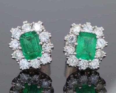 A beautiful pair of Colombian emerald and diamond cluster earrings, set in 18kt white gold. With a combined emerald weight of 1.88 carats, the earrings showcase the rich, unmistakable colour for which Colombian emeralds are so highly prized. The classic cluster arrangement gives these earrings an elegant presence while allowing the emeralds to remain the focal point. The combination of vivid green gemstones and brilliant diamonds creates a timeless pairing suited to both collectors and lovers of fine coloured-stone jewellery.