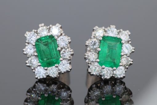 A beautiful pair of Colombian emerald and diamond cluster earrings, set in 18kt white gold. With a combined emerald weight of 1.88 carats, the earrings showcase the rich, unmistakable colour for which Colombian emeralds are so highly prized. The classic cluster arrangement gives these earrings an elegant presence while allowing the emeralds to remain the focal point. The combination of vivid green gemstones and brilliant diamonds creates a timeless pairing suited to both collectors and lovers of fine coloured-stone jewellery.