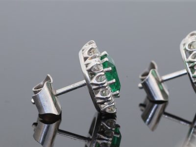 A beautiful pair of Colombian emerald and diamond cluster earrings, set in 18kt white gold. With a combined emerald weight of 1.88 carats, the earrings showcase the rich, unmistakable colour for which Colombian emeralds are so highly prized. The classic cluster arrangement gives these earrings an elegant presence while allowing the emeralds to remain the focal point. The combination of vivid green gemstones and brilliant diamonds creates a timeless pairing suited to both collectors and lovers of fine coloured-stone jewellery.