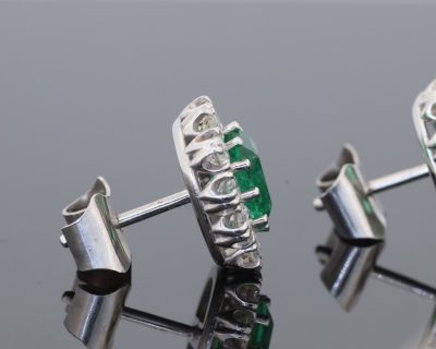 A beautiful pair of Colombian emerald and diamond cluster earrings, set in 18kt white gold. With a combined emerald weight of 1.88 carats, the earrings showcase the rich, unmistakable colour for which Colombian emeralds are so highly prized. The classic cluster arrangement gives these earrings an elegant presence while allowing the emeralds to remain the focal point. The combination of vivid green gemstones and brilliant diamonds creates a timeless pairing suited to both collectors and lovers of fine coloured-stone jewellery.