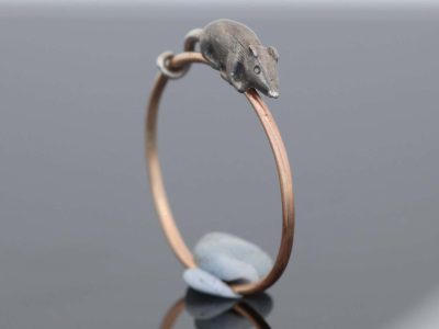 A wonderfully charming Victorian novelty ring by Thornhill & Co., featuring a delightful little mouse in silver. Victorian jewellers were particularly celebrated for their imaginative and whimsical jewels, transforming familiar creatures and objects into highly inventive pieces of wearable art. This unusual ring captures that playful spirit beautifully. Rather than being fixed in place, the little mouse is free-running on the shank, allowing him to spin around the finger. This ingenious feature gives the jewel an engaging sense of movement and makes it an especially memorable example of Victorian novelty jewellery.