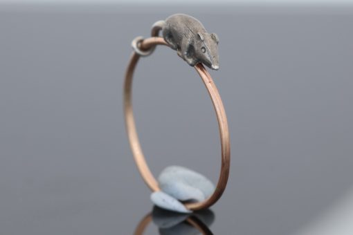 A wonderfully charming Victorian novelty ring by Thornhill & Co., featuring a delightful little mouse in silver. Victorian jewellers were particularly celebrated for their imaginative and whimsical jewels, transforming familiar creatures and objects into highly inventive pieces of wearable art. This unusual ring captures that playful spirit beautifully. Rather than being fixed in place, the little mouse is free-running on the shank, allowing him to spin around the finger. This ingenious feature gives the jewel an engaging sense of movement and makes it an especially memorable example of Victorian novelty jewellery.