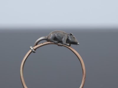 A wonderfully charming Victorian novelty ring by Thornhill & Co., featuring a delightful little mouse in silver. Victorian jewellers were particularly celebrated for their imaginative and whimsical jewels, transforming familiar creatures and objects into highly inventive pieces of wearable art. This unusual ring captures that playful spirit beautifully. Rather than being fixed in place, the little mouse is free-running on the shank, allowing him to spin around the finger. This ingenious feature gives the jewel an engaging sense of movement and makes it an especially memorable example of Victorian novelty jewellery.