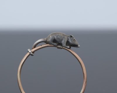 A wonderfully charming Victorian novelty ring by Thornhill & Co., featuring a delightful little mouse in silver. Victorian jewellers were particularly celebrated for their imaginative and whimsical jewels, transforming familiar creatures and objects into highly inventive pieces of wearable art. This unusual ring captures that playful spirit beautifully. Rather than being fixed in place, the little mouse is free-running on the shank, allowing him to spin around the finger. This ingenious feature gives the jewel an engaging sense of movement and makes it an especially memorable example of Victorian novelty jewellery.
