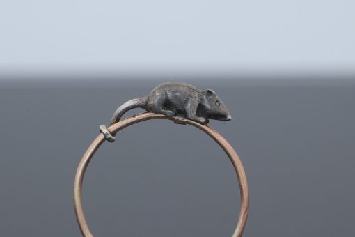 A wonderfully charming Victorian novelty ring by Thornhill & Co., featuring a delightful little mouse in silver. Victorian jewellers were particularly celebrated for their imaginative and whimsical jewels, transforming familiar creatures and objects into highly inventive pieces of wearable art. This unusual ring captures that playful spirit beautifully. Rather than being fixed in place, the little mouse is free-running on the shank, allowing him to spin around the finger. This ingenious feature gives the jewel an engaging sense of movement and makes it an especially memorable example of Victorian novelty jewellery.