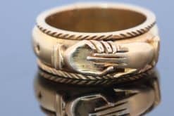 A rare and evocative Georgian “Mane in Fede” memorial ring, made in 1774. The name Mane in Fede refers to the traditional motif of two clasped hands, symbolising faith, fidelity and enduring affection. Memorial rings of this type formed an intimate connection between jewellery and remembrance, often incorporating a lock of the deceased’s hair as a tangible keepsake. This example is particularly intriguing for its ingenious concealed compartment.