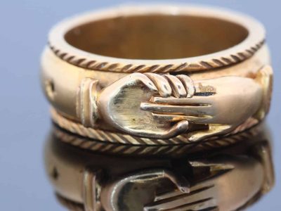 A rare and evocative Georgian “Mane in Fede” memorial ring, made in 1774. The name Mane in Fede refers to the traditional motif of two clasped hands, symbolising faith, fidelity and enduring affection. Memorial rings of this type formed an intimate connection between jewellery and remembrance, often incorporating a lock of the deceased’s hair as a tangible keepsake. This example is particularly intriguing for its ingenious concealed compartment.